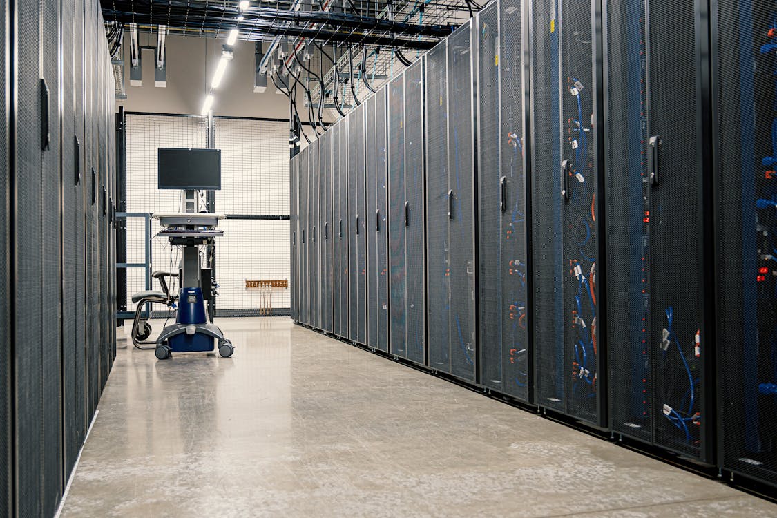 Steel server racks with networking cables in a modern data center